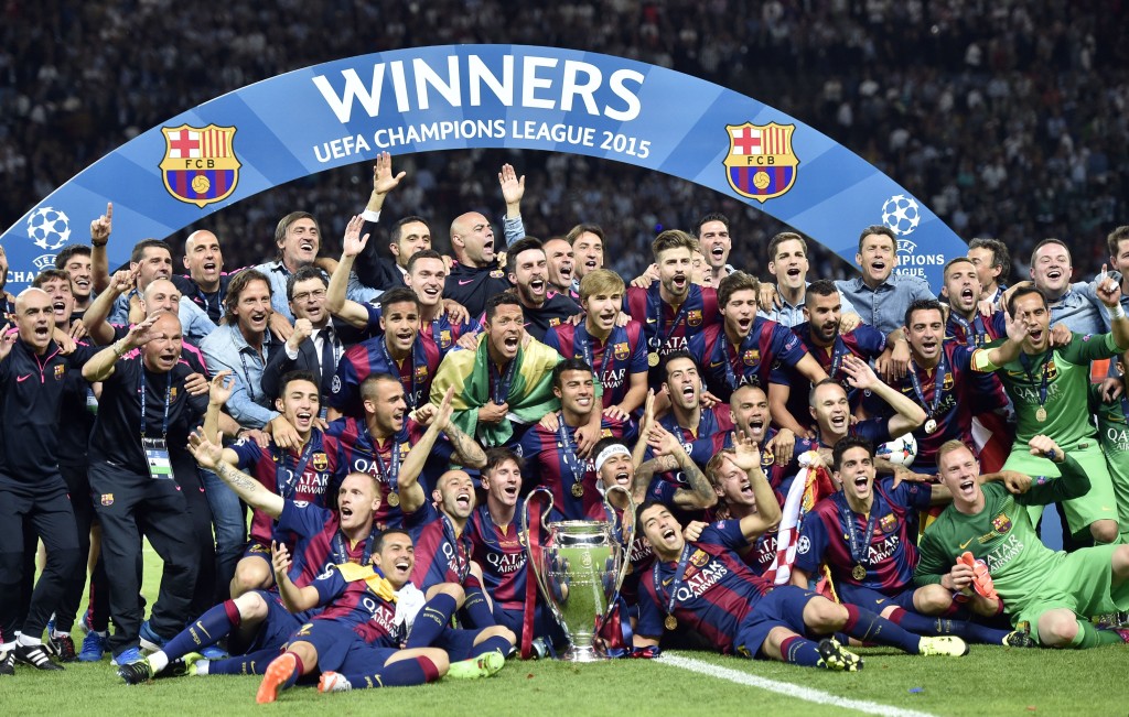 Barcelona team and staff celebrate with the trophy after winning 3-1 the Champions League final soccer match between Juventus Turin and FC Barcelona at the Olympic stadium in Berlin Saturday, June 6, 2015. (AP Photo/Martin Meissner)